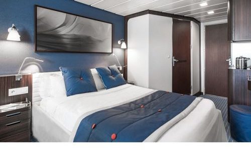 Schlaf und Wohnbereich der Antigua Kabine auf dem Luxussegelschiff Le Ponant